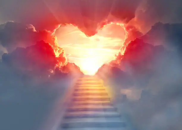Photo of Stairway to Heaven.Stairs in sky.  Concept with sun and clouds.  Religion  background. Red heart shaped sky at sunset. Love background with copy space.