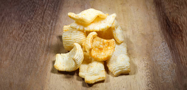istock Potato chips on wooden background .Potato chips snacks food. 1367365971