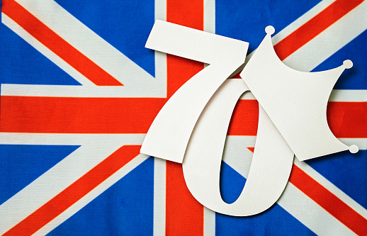 Creative british style platinum anniversary background with number seventy, crown and united kingdom uk flag