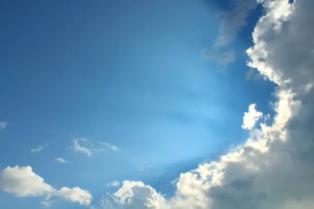 Photo of Large lush clouds and sunrays. Background. Landscape.