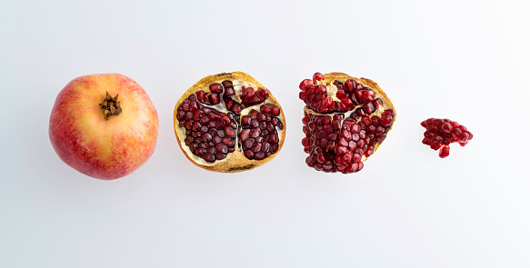 Pieces of pomegranate on white background.