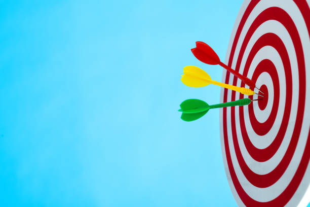 istock Dart arrows on center of dartboard 1367370850