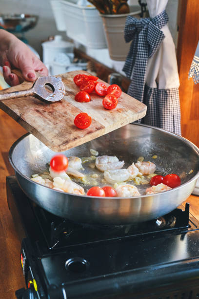 istock Preparing Spaghetti Nero Pasta with Shrimp Scampi and Cherry Tomato 1367370903