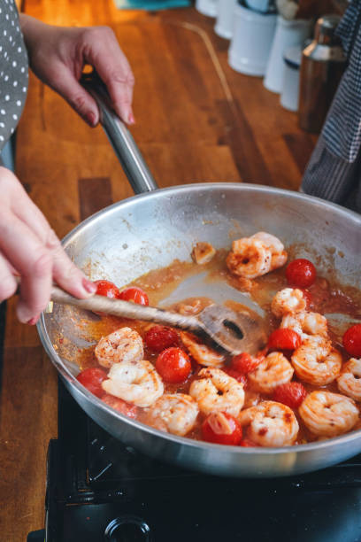 istock Preparing Spaghetti Nero Pasta with Shrimp Scampi and Cherry Tomato 1367370914