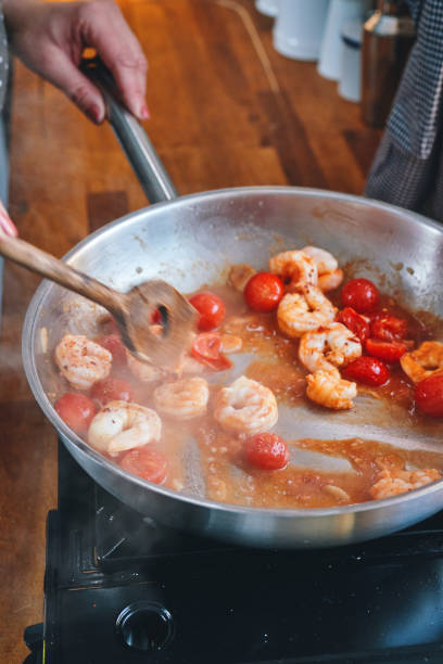 istock Preparing Spaghetti Nero Pasta with Shrimp Scampi and Cherry Tomato 1367370915