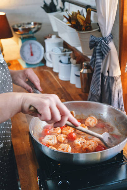 istock Preparing Spaghetti Nero Pasta with Shrimp Scampi and Cherry Tomato 1367370921