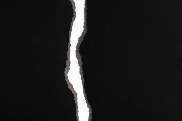 istock Background of torn black paper 1367371003