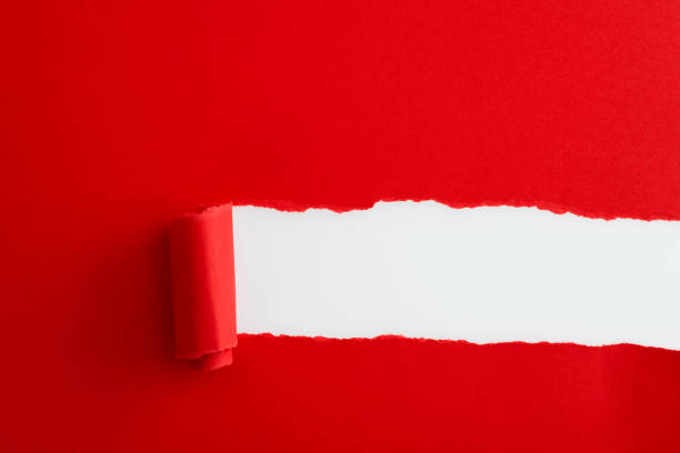 istock Red paper tearing a hole 1367371160