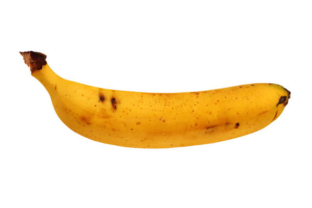 This is a color photograph of a banana with googly eyes on a bright colored background.