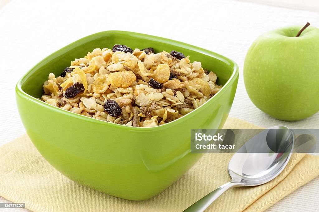 healthy granola and fresh apple delicious and healthy granola or muesli with fresh organic apple, with lots of dry fruits, nuts and grains. Apple - Fruit Stock Photo