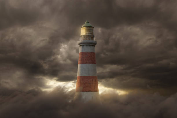 istock 3d rendering of an illuminated lighthouse over fluffy clouds and dark sky 1367373425