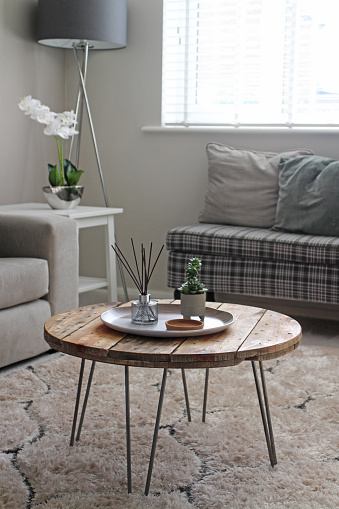 A wooden pallet turned into a coffee table in a modern setting.
