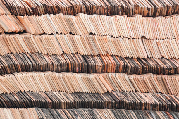 Heap red corrugated tile element of roof retro for construction,ready to use in construction site in temple Thailand