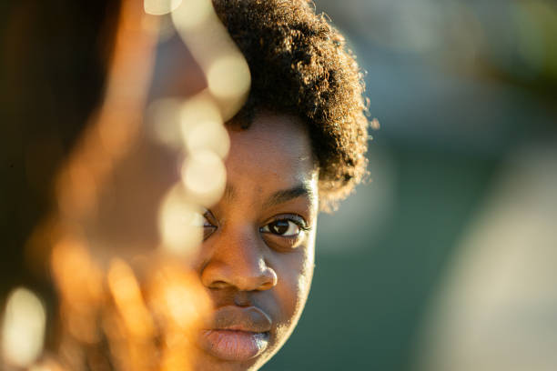 profondità di campo ridotta ritratto di ragazze afroamericane alla luce naturale del sole - teenager adolescence portrait pensive foto e immagini stock