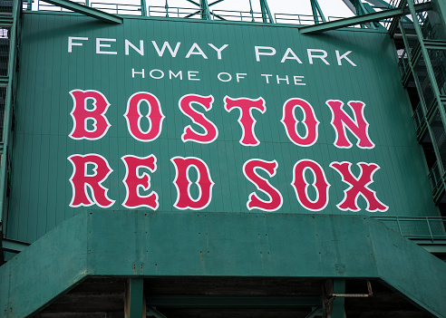 Boston, MA, USA - July 20, 2018: view of the historic architecture of the Fenway Park stadium in Boston, Massachusetts, USA with its sings, monuments, and gates' entrances.