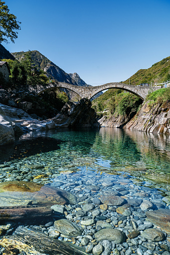 old roman bridge over turquoise river in the verzasca valley in the swiss ticino canton