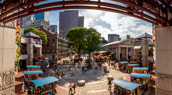 Boston, MA, USA - July 12, 2016: view of the historic architecture of Boston in Massachusetts, USA at Quincy Market and Faneuil Hall in Boston downtown with tons of tourists and locals passing by enjoying themselves.
