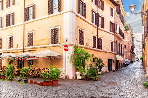 Traditional cozy Italian street with a cafe near Coliseum, Rome, no people.
