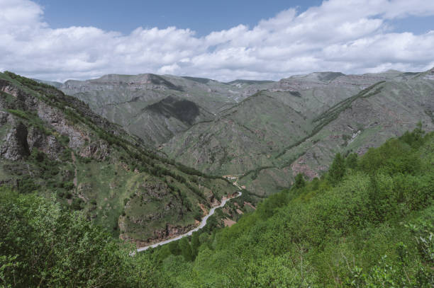 istock a road in a valley among the mountains in summer 1367379239