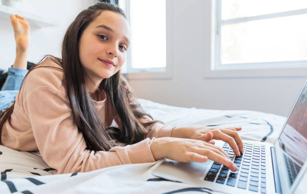 istock Nice teenage girl using a computer in her bedroom. 1367380615
