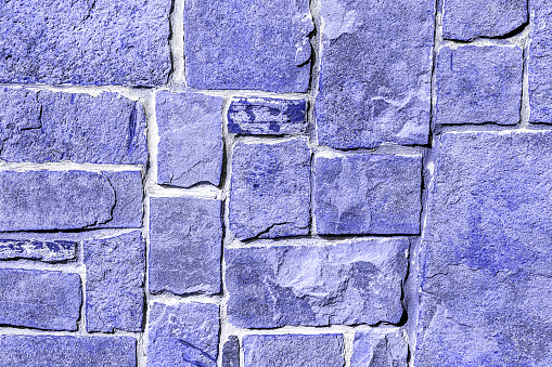 Section of an old brick wall freshly painted blue.