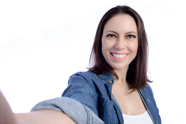 istock Young woman looking at cellphone to take selfie 1367382069