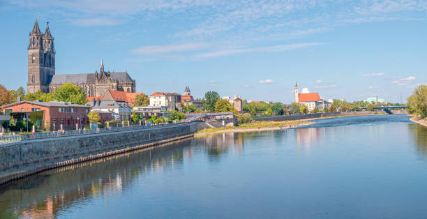 Panoramic view over historical downtown of Magdeburg, old town, Elbe river, new modern houses and Magnificent Cathedral at early Autumn with blue sky and sunny day, Magdeburg, Germany. stock photo