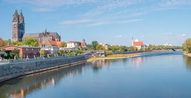Panoramic view over historical downtown of Magdeburg, old town, Elbe river, new modern houses and Magnificent Cathedral at early Autumn with blue sky and sunny day, Magdeburg, Germany