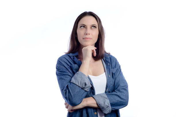 istock Young pensive woman in studio with white background 1367382696