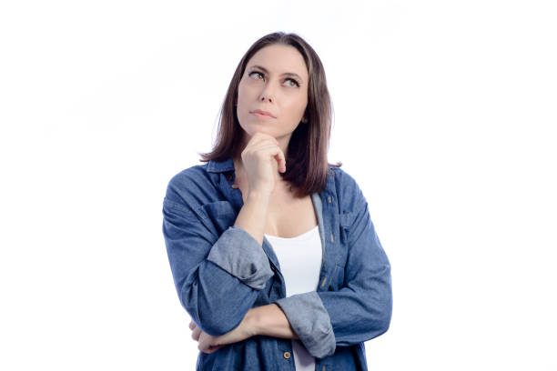 istock Young woman with doubtful expression in studio with white background 1367382738