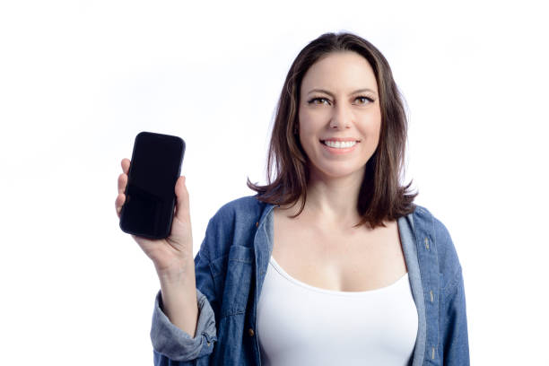 istock Young woman showing cellphone screen to camera 1367382780