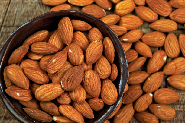 istock Bowl with shelled almond on wooden table 1367383756