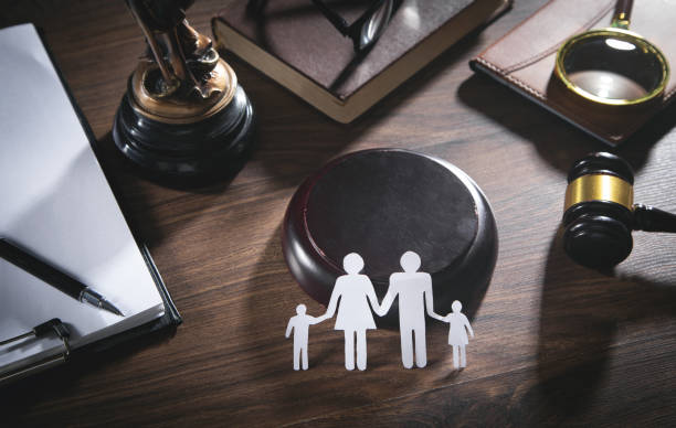 Paper cut family, judge gavel, book and other objects. Family Law stock photo
