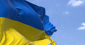 Detail of the national flag of Ukraine waving in the wind on a clear day