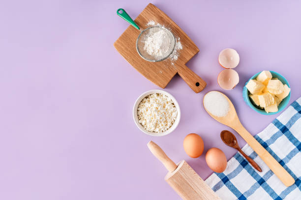 istock Various products and ingredients for baking at home on a purple background. Copy space, top view. 1367386358