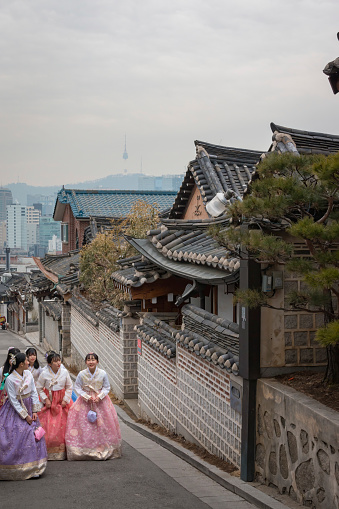 Seoul, South Korea - February 27, 2018: Young Women in traditional Korean dresses at Bukchon Hanok Village in Seoul, South Korea