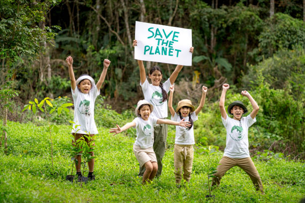 Children join as volunteers for reforestation, earth conservation activities to instill in children a sense of patience and sacrifice, doing good deeds and loving nature. stock photo