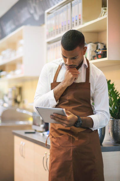 istock Young afro-american bar owner ordering stock 1367390439