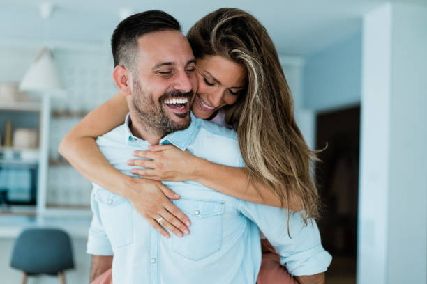 istock Young happy couple piggybacking at home. 1367390457