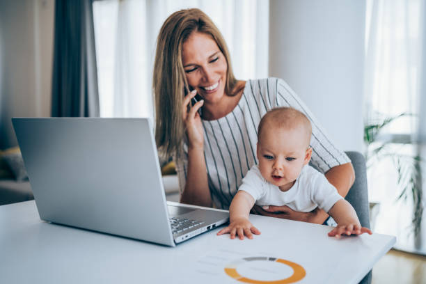 istock Mother and baby working at home. 1367390495