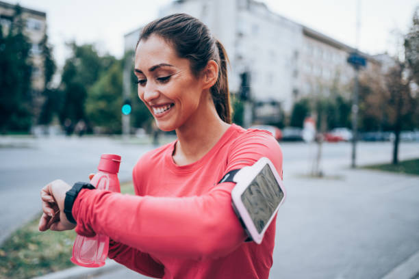 istock Sporty young woman checking the time after jogging. 1367390506