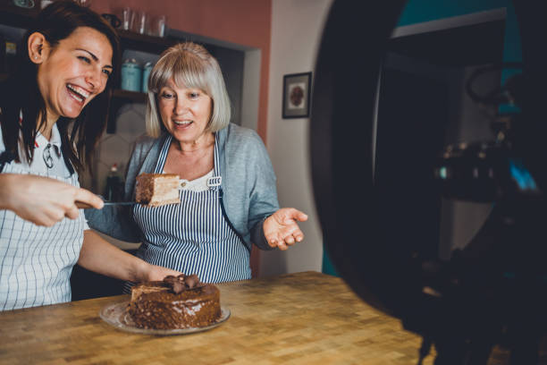 istock Cheerful women recording vlog about cooking. 1367391549