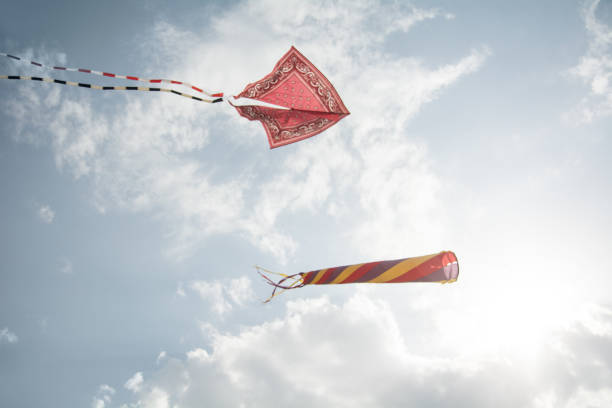 Kites and cloudy sky Kites and cloudy sky kite sailing stock pictures, royalty-free photos & images