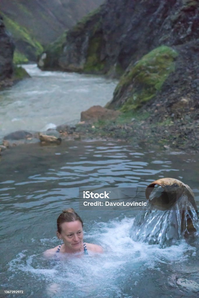 Senior woman enjoying night bath in hot springs near camping Kerlingarfjoll on Iceland Senior woman enjoying night bath in hot springs near Kerlingarfjoll resort. Camping and and guest house with cottages and beautiful trail to geothermal area. Active Lifestyle Stock Photo