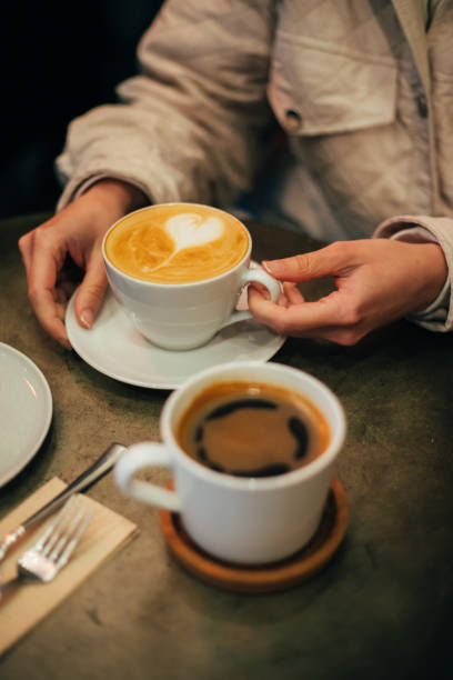 istock Woman holding a cup of latte 1367393323