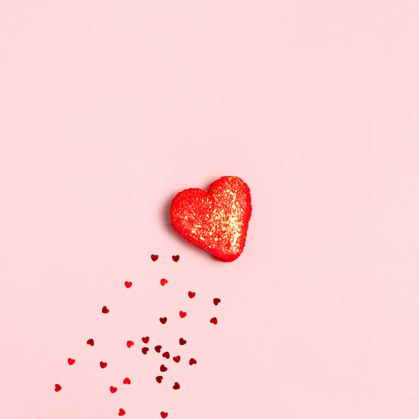 istock Heart Shaped Macaroon Cake and confetti on pink background top view Flat lay. Creative composition for Valentine's Day, love concept, birthday present, mother day, holiday background. Love for sweets 1367393382