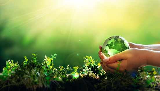 Earth Day.Hand holding crystal earth globe.Environment day, save clean planet, ecology concept.Renewable energy-based green businesses can limit climate change and global warming