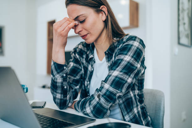istock Stressed woman using laptop at home. 1367394264