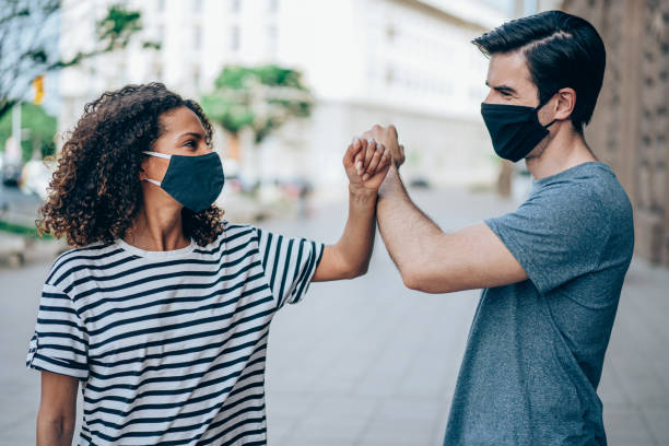 istock Elbow bump greeting on the street. 1367394271