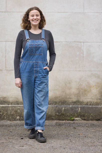 istock Young lady wearing bib overalls 1367394304